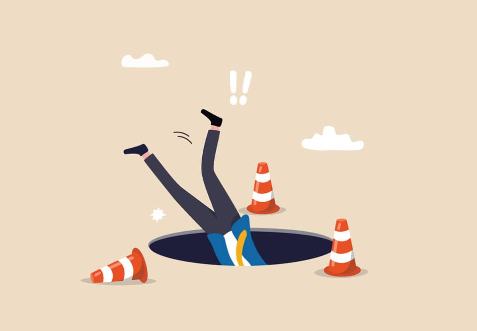 An illustration of a person falling headfirst into a hole even though there are caution cones around it